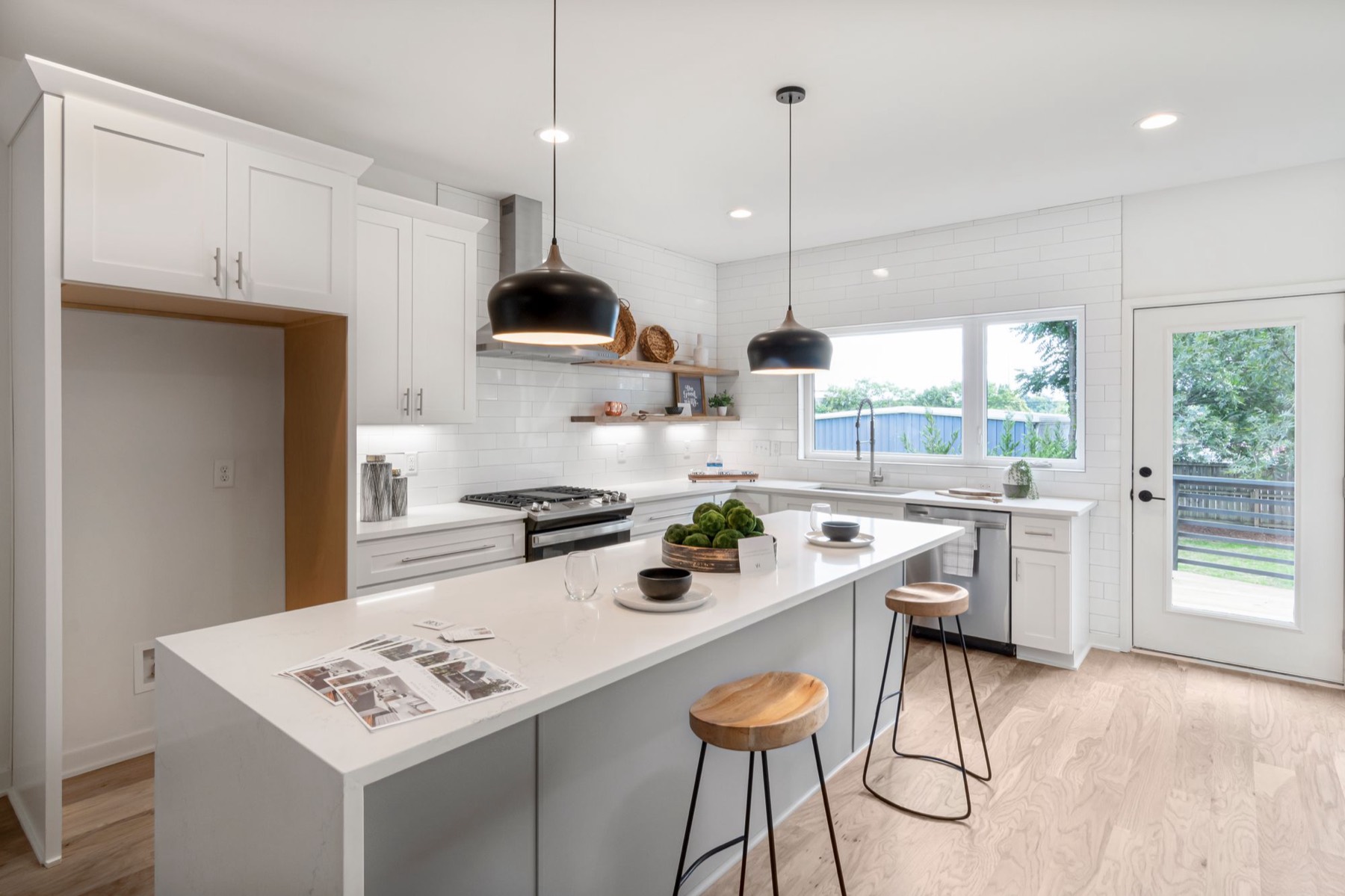 An open-plan kitchen with a cooker circuit, island power and pendant lighting all landing in the same room — each on its own way at the board.