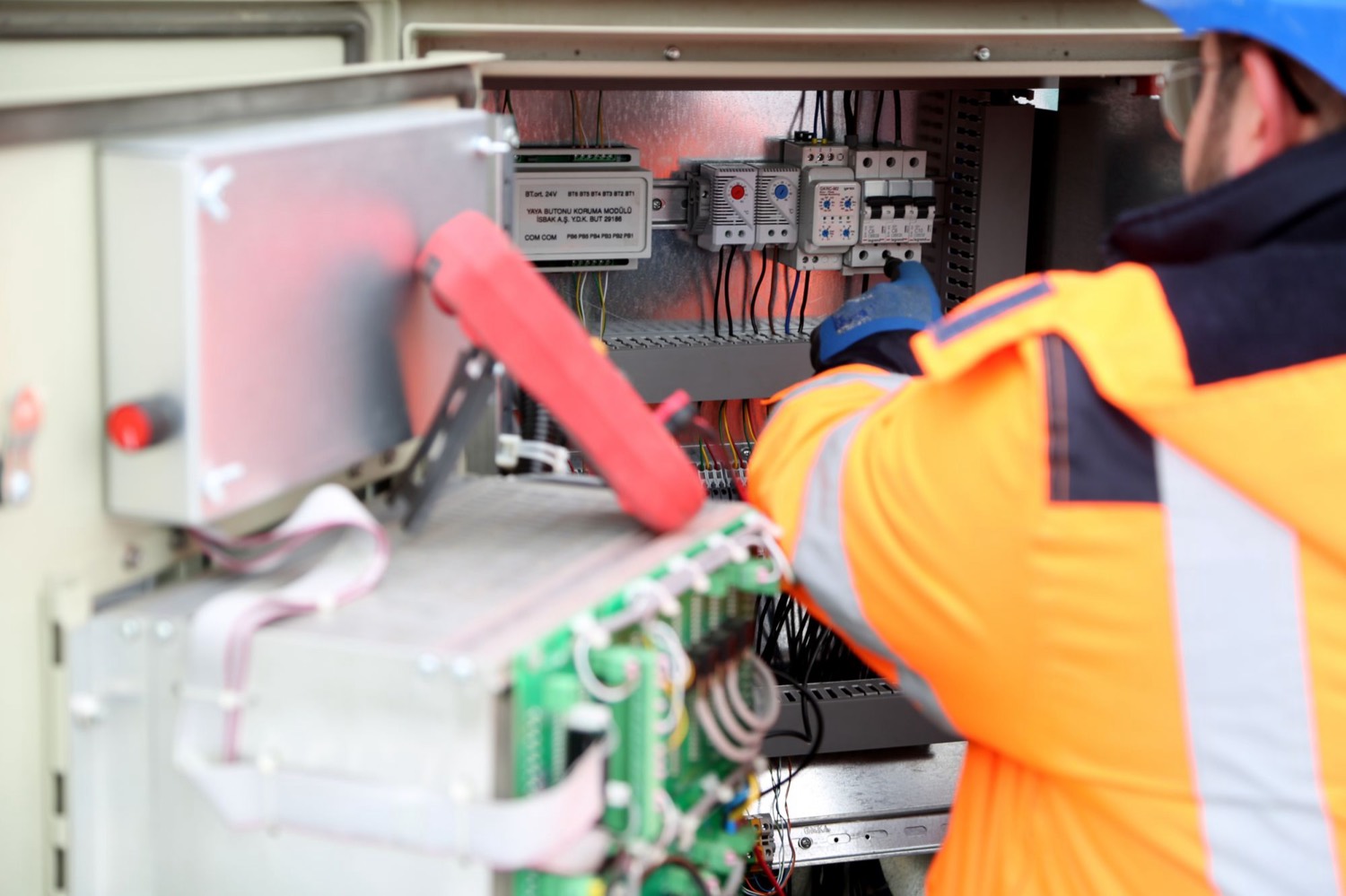 Distribution and control gear being worked on during a maintenance visit — the ongoing half of commercial work rather than the installation half.